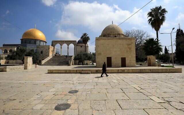 A man walks past the Dome of the Rock, in the Temple Mount compound, in the Old City of Jerusalem on March 16, 2020. (Emmanuel DUNAND/AFP) A man walks past the Dome of the Rock, in the Temple Mount compound, in the Old City of Jerusalem on March 16, 2020. (Emmanuel DUNAND/AFP)